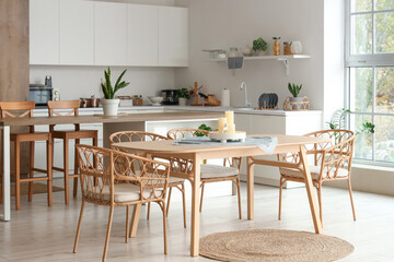 Stylish interior of kitchen with candles on dining table