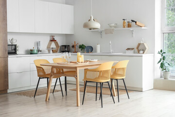 Candles on tray on table in interior of modern kitchen