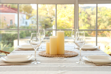 Table setting with candles in dining room