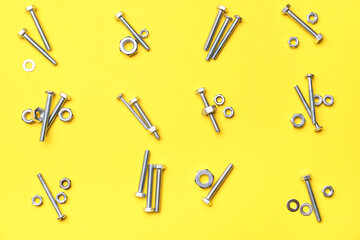 Sets of different tap bolts and chrome nuts on yellow background
