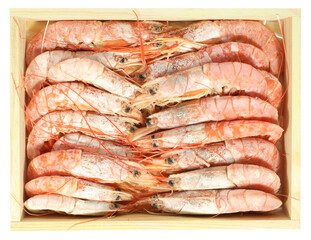 Frozen shrimps fresh sea food in wooden crate isolated on white background