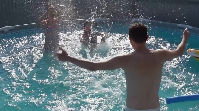 Father is splashing water on his two little daughters in the round swimming pool on the backyard outdoors in the bright sunlight. High quality 4k footage