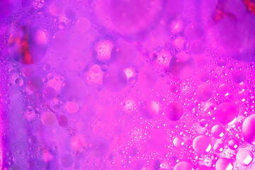Vibrant oil bubbles floating in colorful water for abstract imagery.