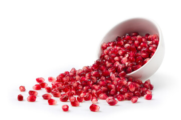 Pomegranate seeds with white bowl isolated on white background.