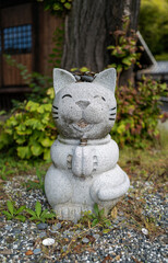 A smiling cat statue at a shrine on the island of Naoshima