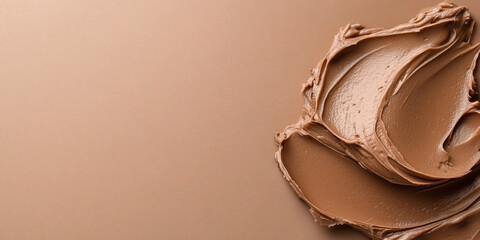 Creamy mocha mousse smear on brown background, trend color of 2025. Copy space, banner