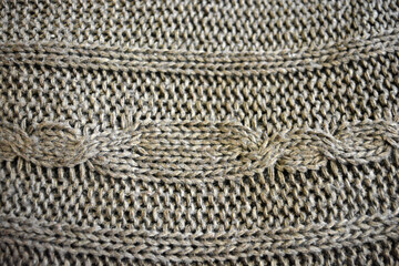 Women's clothing, stylish knitwear made of natural woolen dense threads. Beautiful patterns, braids, nice, soft braided woolen fabric.
