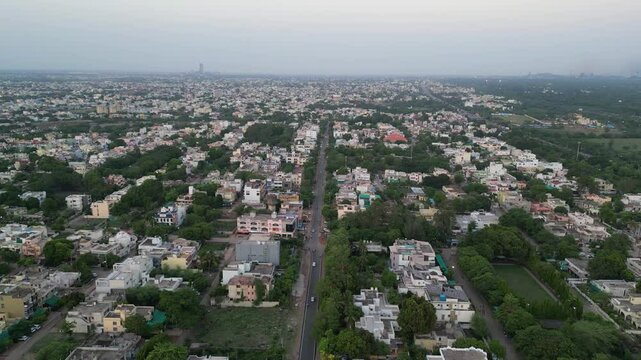 Aerial cityscape of small city or town in India. Roads of developing India. Drone view of rooftops and urban slums in a small city. 4K