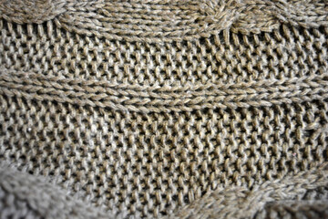 Women's clothing, stylish knitwear made of natural woolen dense threads. Beautiful patterns, braids, nice, soft braided woolen fabric.