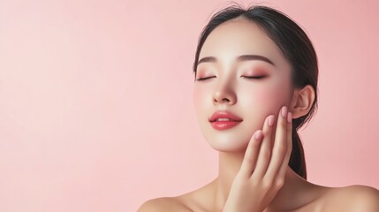 A beautiful young woman with her eyes closed and her hand touching her cheek.