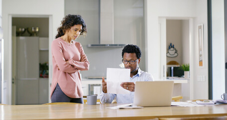 Interracial couple, documents and laptop with eviction notice for financial crisis, bills or home...