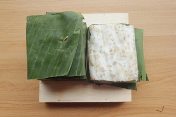 raw tempeh on wooden table