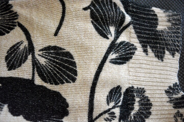 Knitwear, women's clothing, cotton products, unusual fabric backgrounds. Beige fabric, finely weaved, dyed with large black flowers with leaves on a background of small gathering, elastic.