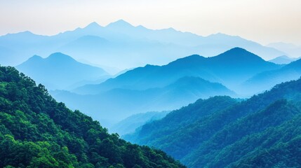 Fototapeta premium Smoky mountain valley fading to blue sky in the early morning