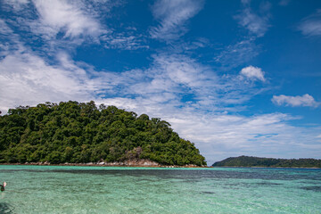 The blue sky and the clear green sea are beautiful.