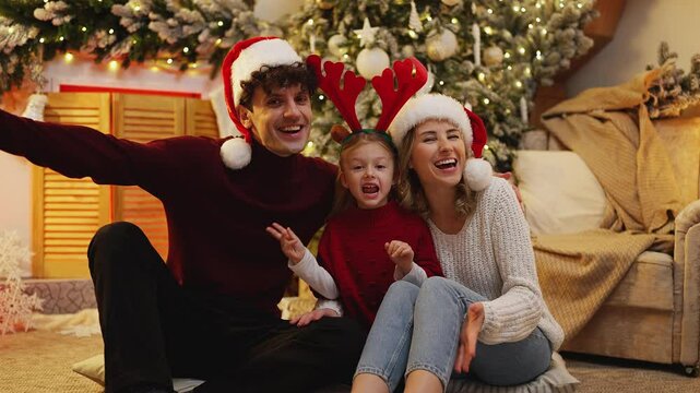 Portrait of a family in party hats, sending Christmas and New Year greetings