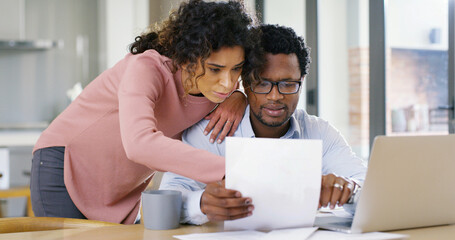 Fototapeta premium Interracial couple, documents and laptop with finance for budget planning, expenses or bills at home. Man, woman or paperwork with computer for mortgage payment, invoices or financial report at house