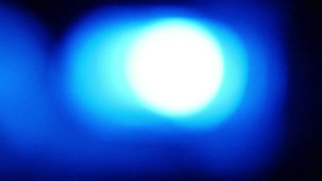 Seamless loop of blurred emergency blue flashing lights
