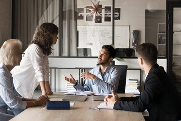Group of professionals engaged in teamwork, collaboration, and strategy planning gathered at...