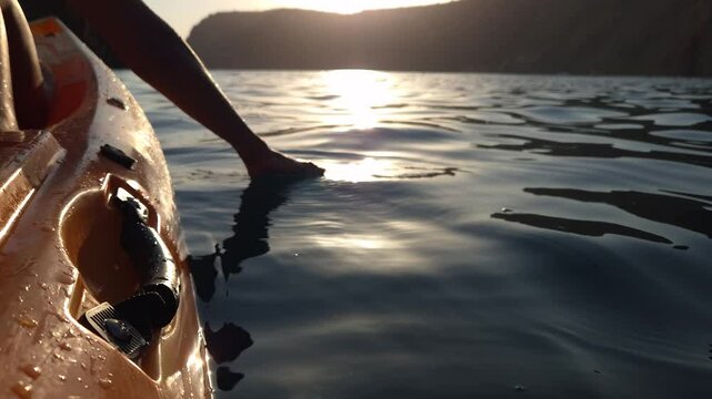 Jet Ski, Sunset, Ocean - A person's feet hang off the back of a jet ski at sunset on the ocean.
