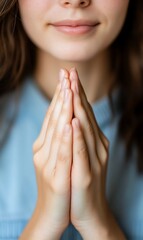 A close-up of a person?s hands in a prayer-like gesture.