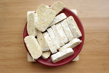raw tempeh on wooden table