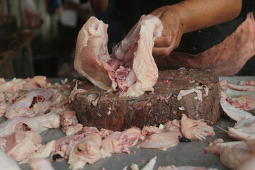 butcher cutting meat on board