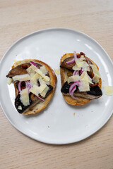 Toasted bread with mushroom, onion, and cheese.