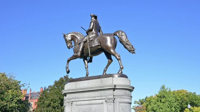 The Boston Public Garden with its famous and iconic George Washington sculpture on a sunny day in Boston, Massachusetts, USA.