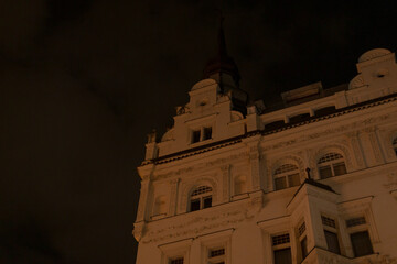 A large and impressive building, featuring a prominent steeple, is beautifully illuminated and...