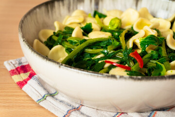 The traditional dish of orecchiette with turnip green, typical of Puglia, Italy, side view