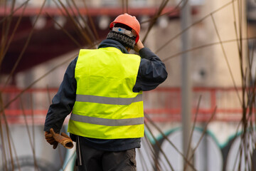 Builder with a red helmet at the construction  site
