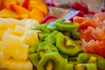 Exotic fruit. Exotic summer fruits of pineapple, dragon fruit, pitaya, diospyros, grapefruit and kiwi. Exotic vitamin salad. Tropical salad. Island food. Luxury fruit mix. Tropical food. Exotic aroma