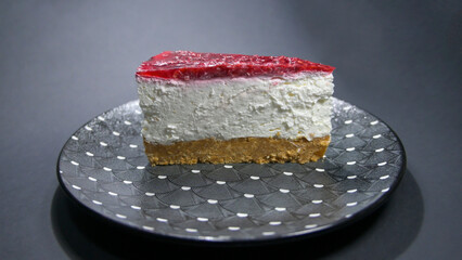 Sliced ​​piece of Cheesecake on a gray plate