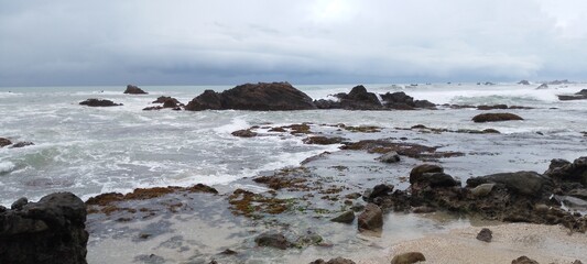 view of the sea from the beach with sea rock