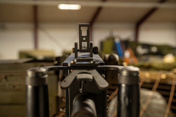 View over the front and rear sight of a Calibre .50 machine gun on the turret of a military tank