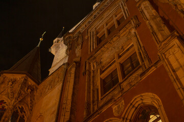 A magnificent building stands tall with a statue elegantly perched on top of it, illuminated at...