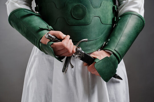 Assassin Knight. Male armoured hands holding steel whinger knife.