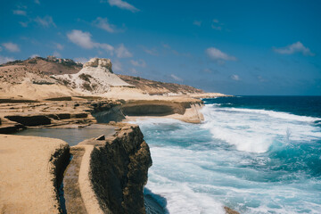 Beautiful seascape with traditional salt pans in Xwejni Bay on the island of Gozo on a sunny day, Marsaskala, Malta. 