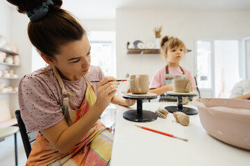 A pottery class for children in a bright, cozy studio during the afternoon