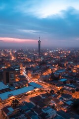 Fototapeta premium A stunning cityscape at dusk featuring a tall communication tower amidst the urban landscape.