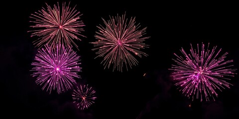Vibrant Fireworks Display in Night Sky with Pink and Purple Explosions