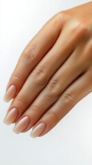 Close-up of a hand with natural nails and a neutral manicure