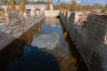 Obraz premium Abandoned Industrial Ruins Reflecting in Still Waters