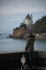 woman watching the sunset with her dog in Biarritz