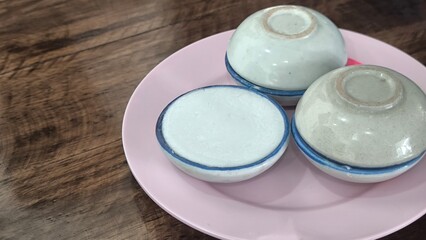 kanom tuay Thai dessert coconut milk custard in small porcelain cup .