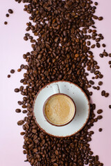 coffee cup with coffee beans on pastel background. flat lay, top view