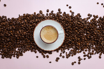 coffee cup with coffee beans on pastel background. flat lay, top view