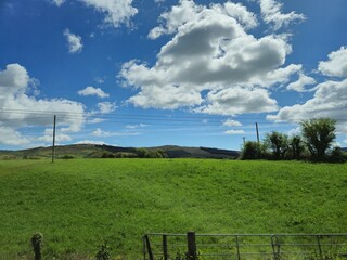 Cumulus Clouds Over Grassland Landscape © Studio-M