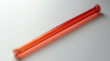 A single, translucent, amber-colored glass tube lies diagonally on a white background.